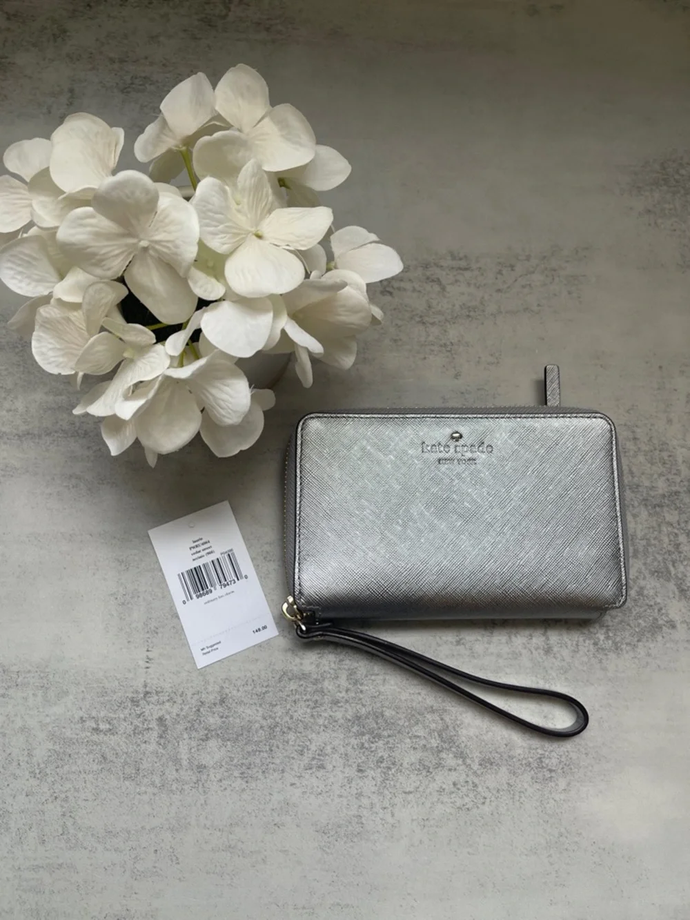 Kate Spade Laurie silver zip-around wristlet wallet